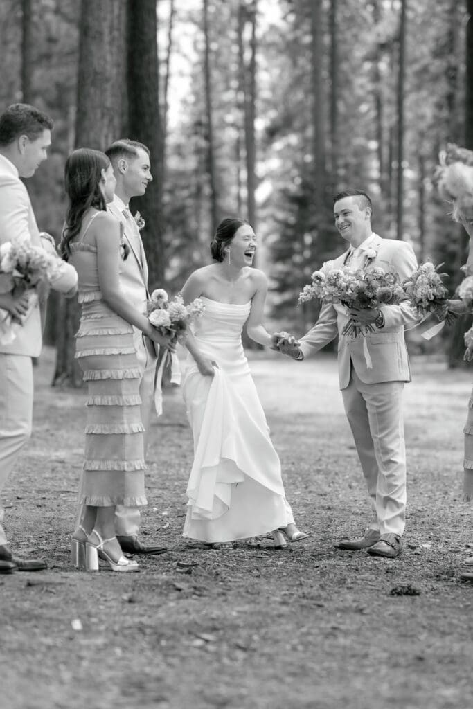 Bride and groom laughing and holding hands during the first look at lot b at Edgewood Resort Tahoe.