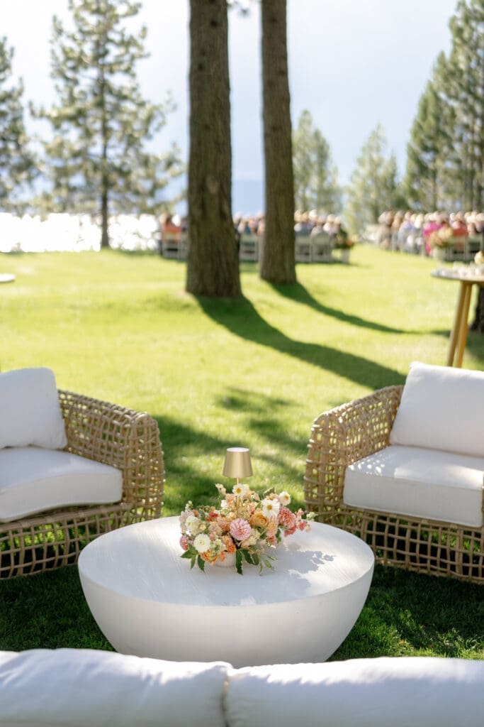 Lounge seating and floral arrangements overlooking the ceremony lawn at Edgewood Resort.