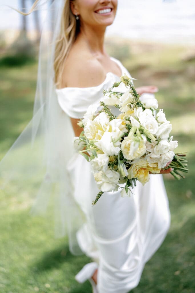 Bride holding white floral bouquet during Edgewood Tahoe 17th Green wedding portraits