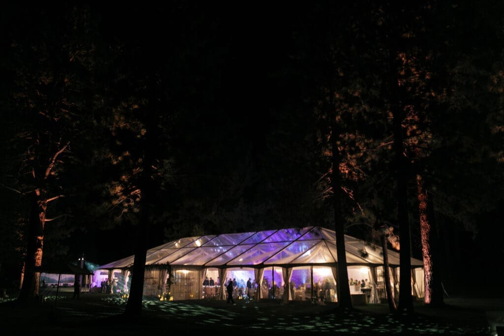 Clear top wedding tent illuminated at night during an Edgewood Tahoe 17th Green reception in Lake Tahoe