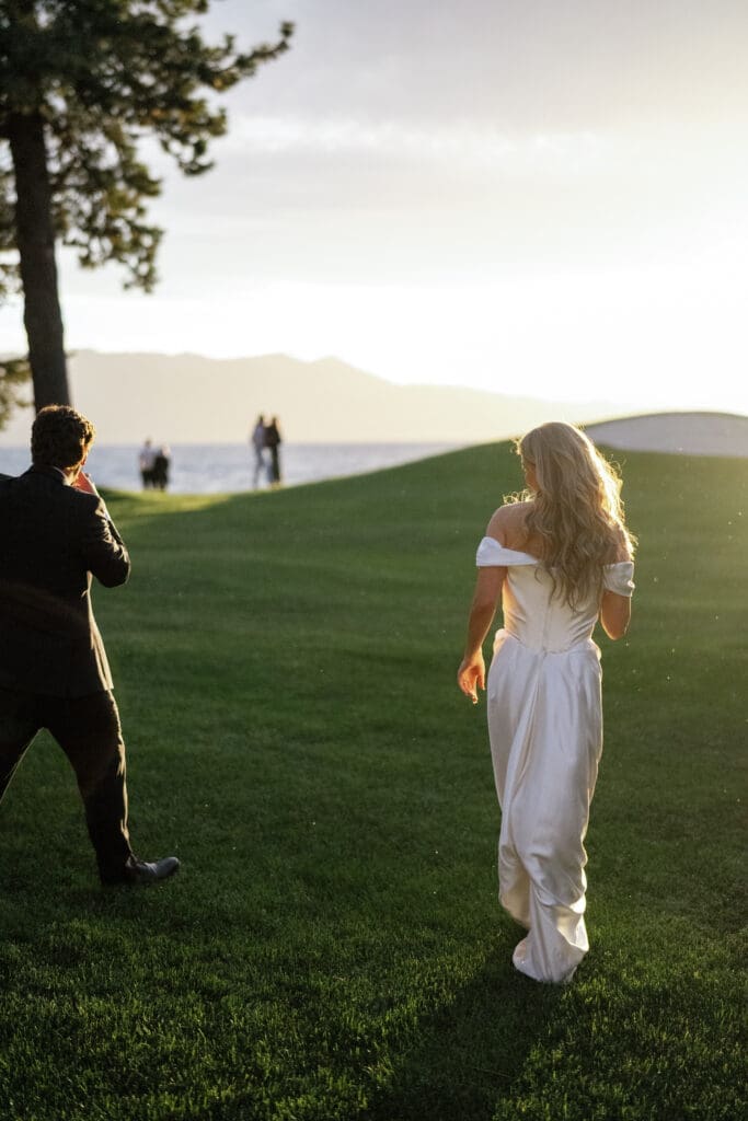 Bride and groom walking along the shoreline at sunset after their Edgewood Tahoe wedding ceremony