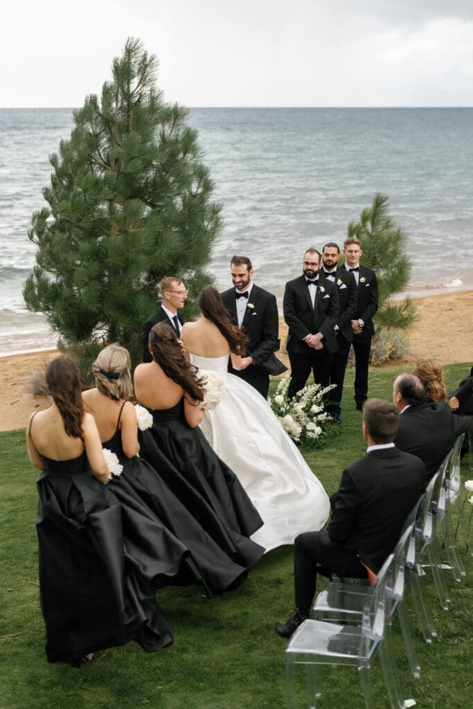 Lakefront wedding ceremony at Edgewood Tahoe with the bridal party overlooking Lake Tahoe.