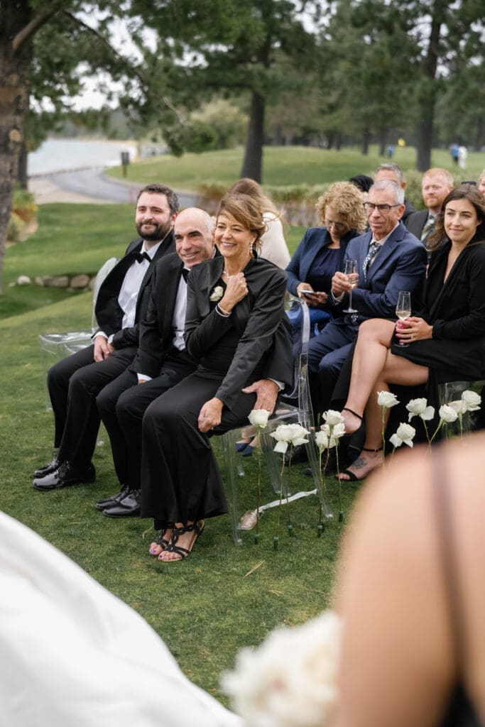 Guests watching a wedding ceremony on the lakefront lawn at Edgewood Tahoe.