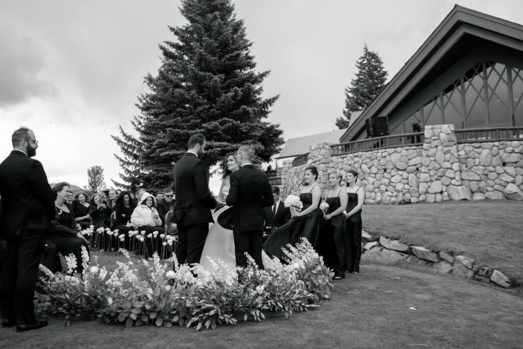 Wedding ceremony on the North Room lawn at Edgewood Tahoe with the lodge and reception pavilion in the background.
