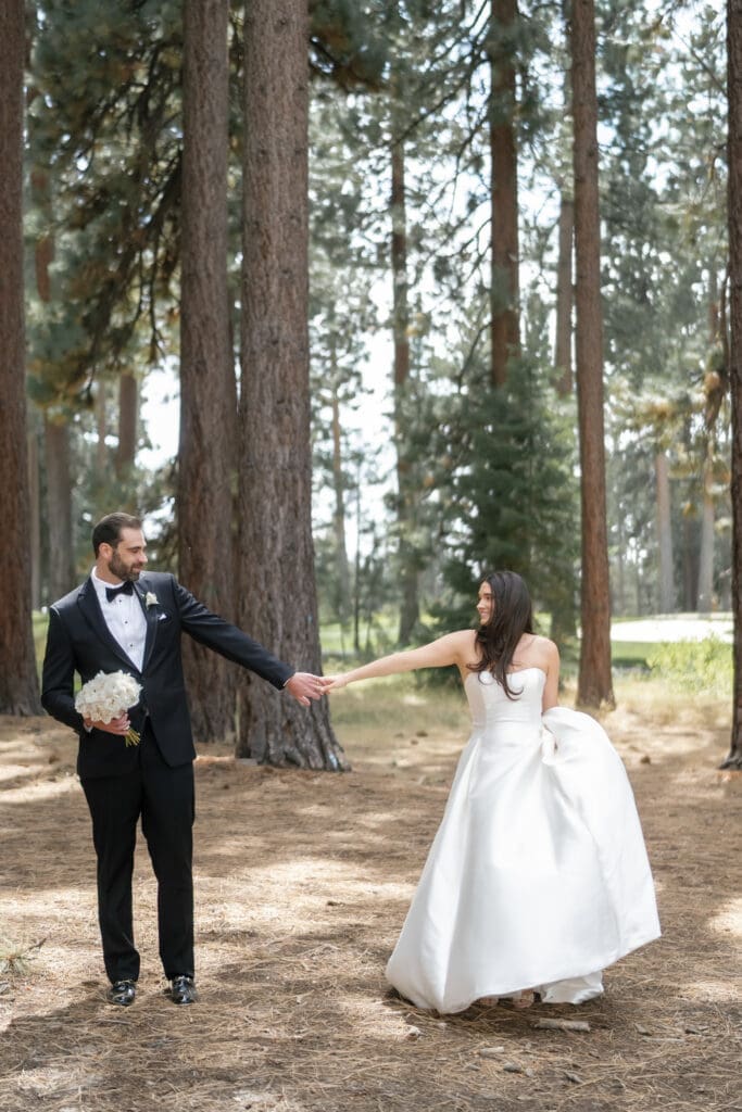 Bride and groom portraits beneath the pine trees in lot B at Edgewood Tahoe Golf Course