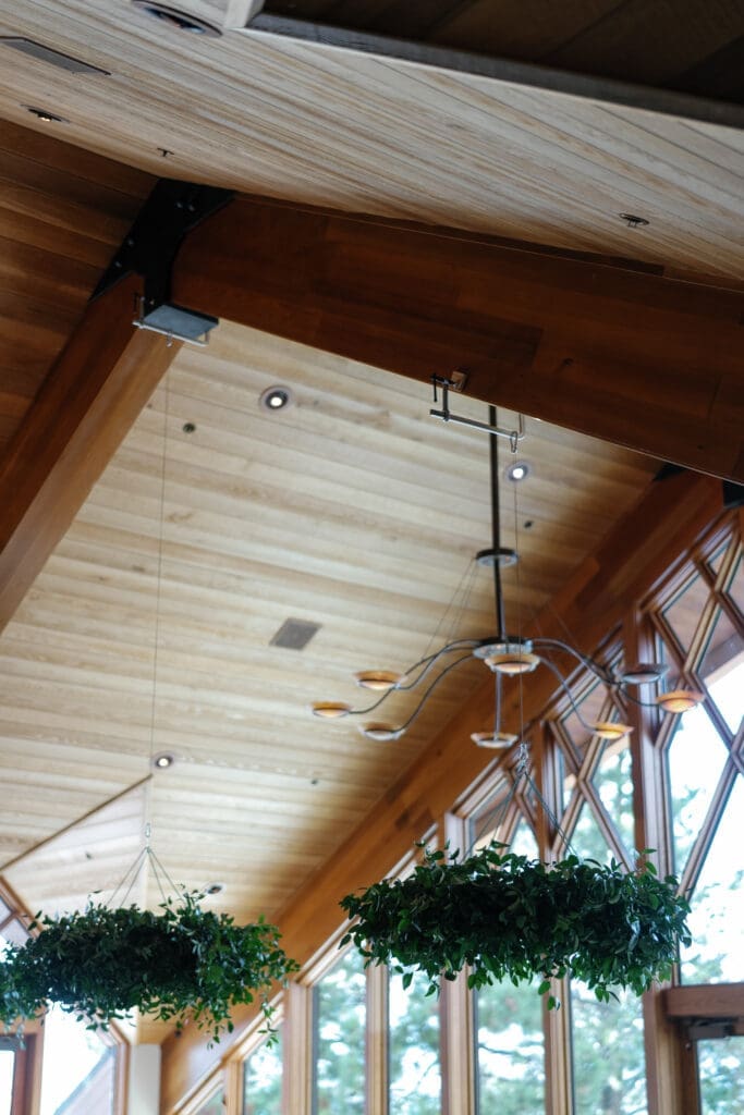 Wood-beam architecture and reception details inside the Edgewood Resort Lake Club.