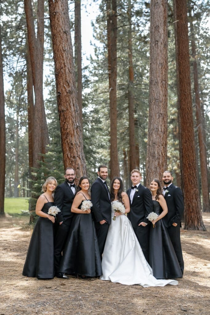 Wedding party portrait beneath tall pine trees in lot B at Edgewood Tahoe in Lake Tahoe