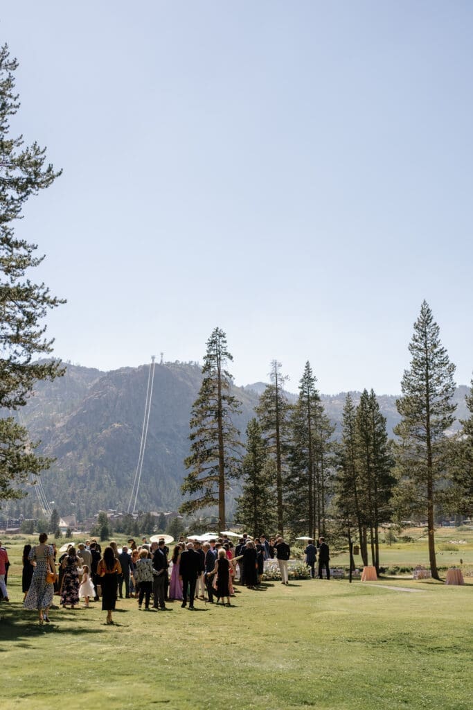 Guests gathering on the lawn during an Everline Resort Lake Tahoe wedding cocktail hour