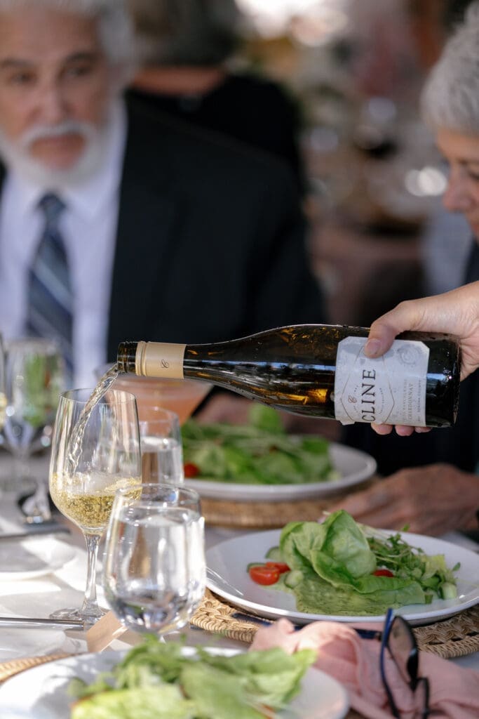 Dinner service during a tented wedding reception at Everline Resort Lake Tahoe