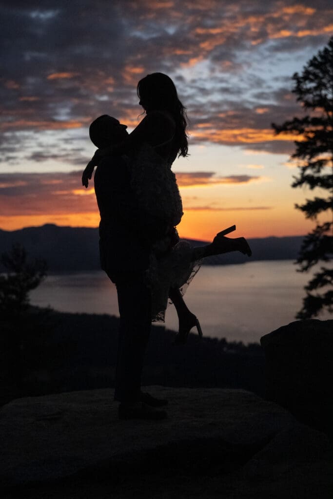 Silhouette portrait of a couple overlooking Lake Tahoe at sunset during a Heavenly Mountain wedding.