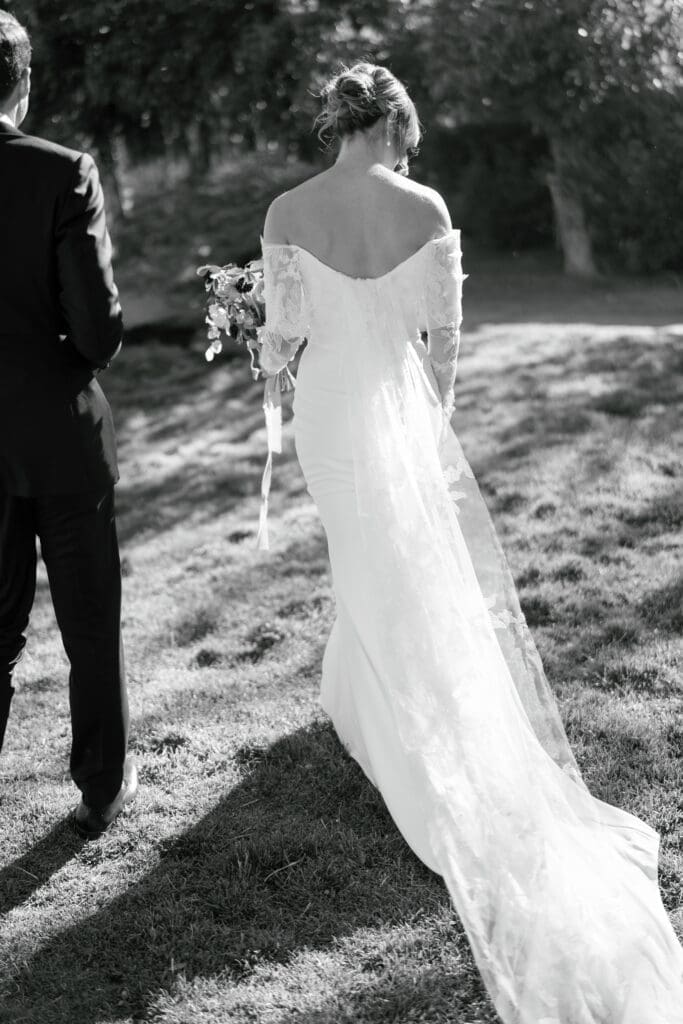 Bride walking through the grass during golden hour portraits at Gar Woods Grill & Pier in North Lake Tahoe.