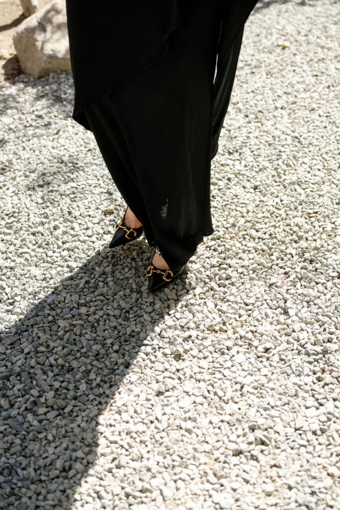 Black heels walking across gravel during a private estate wedding in Lake Tahoe.