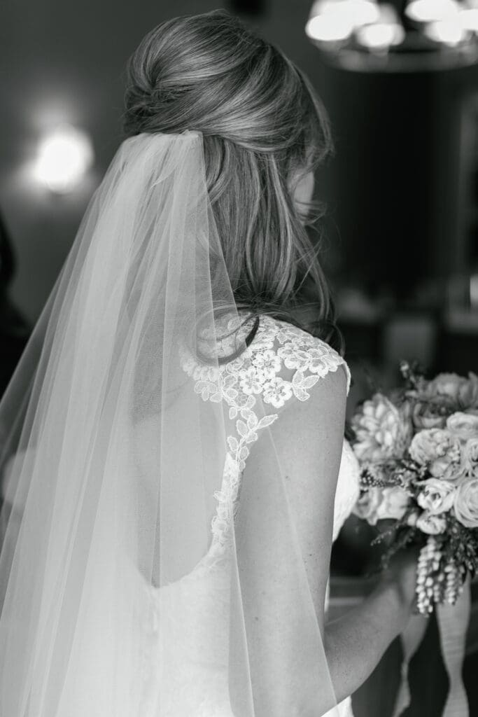Black and white bridal portrait featuring veil and lace wedding gown during Martis Camp wedding
