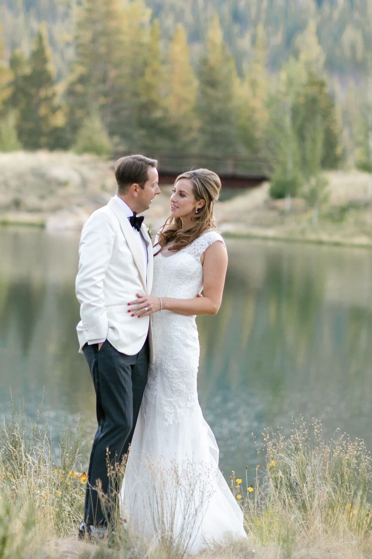 Bride and groom portrait beside alpine lake during sunset at Martis Camp wedding venue