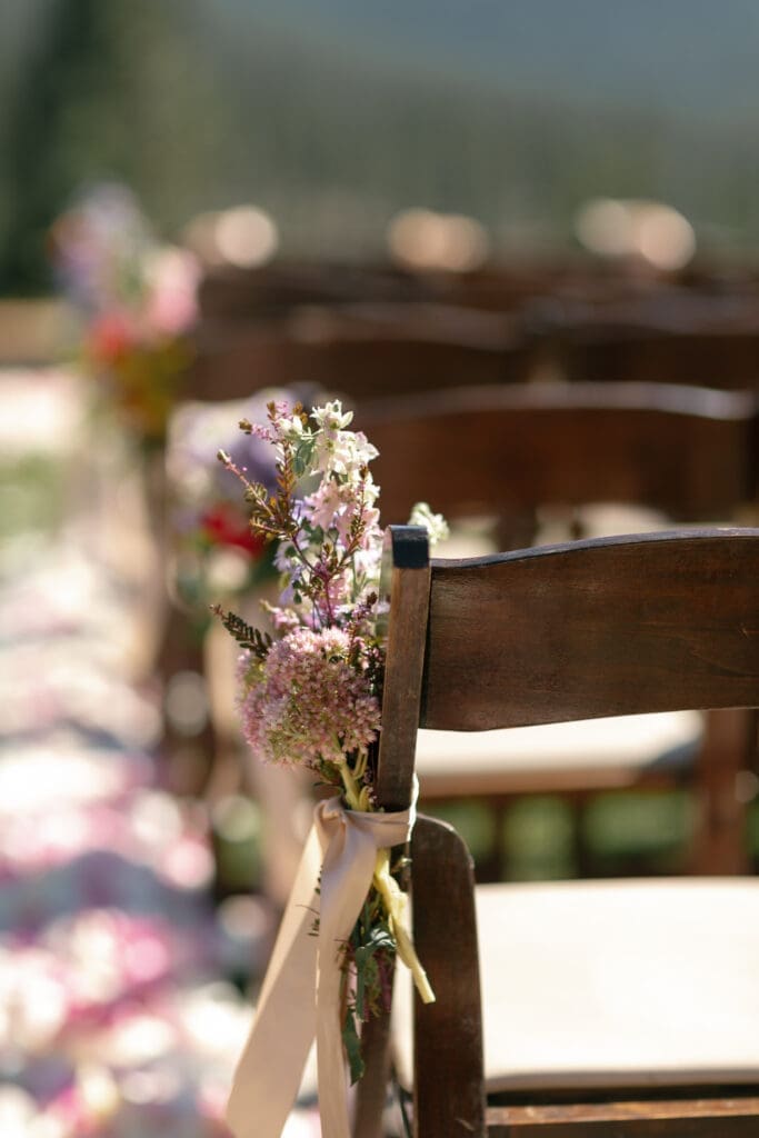 Ceremony chair floral arrangement detail during luxury outdoor Martis Camp wedding