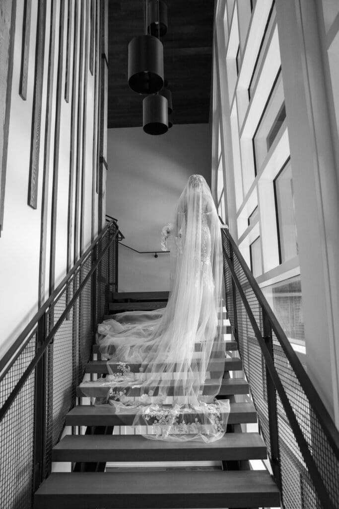 Black and white bridal portrait with cathedral veil on modern staircase at Tahoe Beach Club