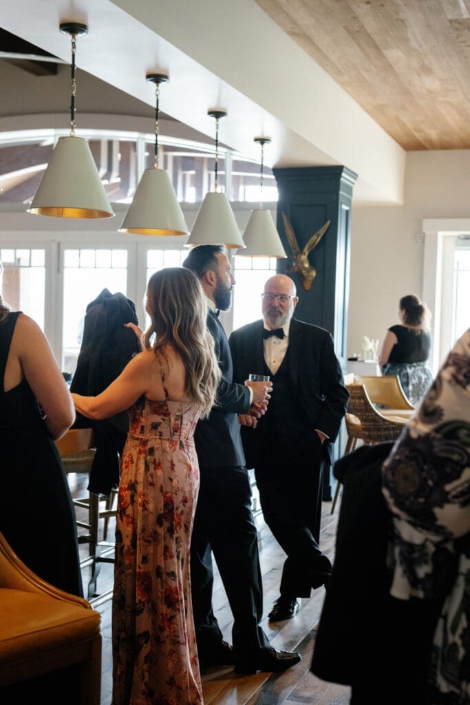 Guests mingling during upscale cocktail hour inside Tahoe Beach Club wedding venue