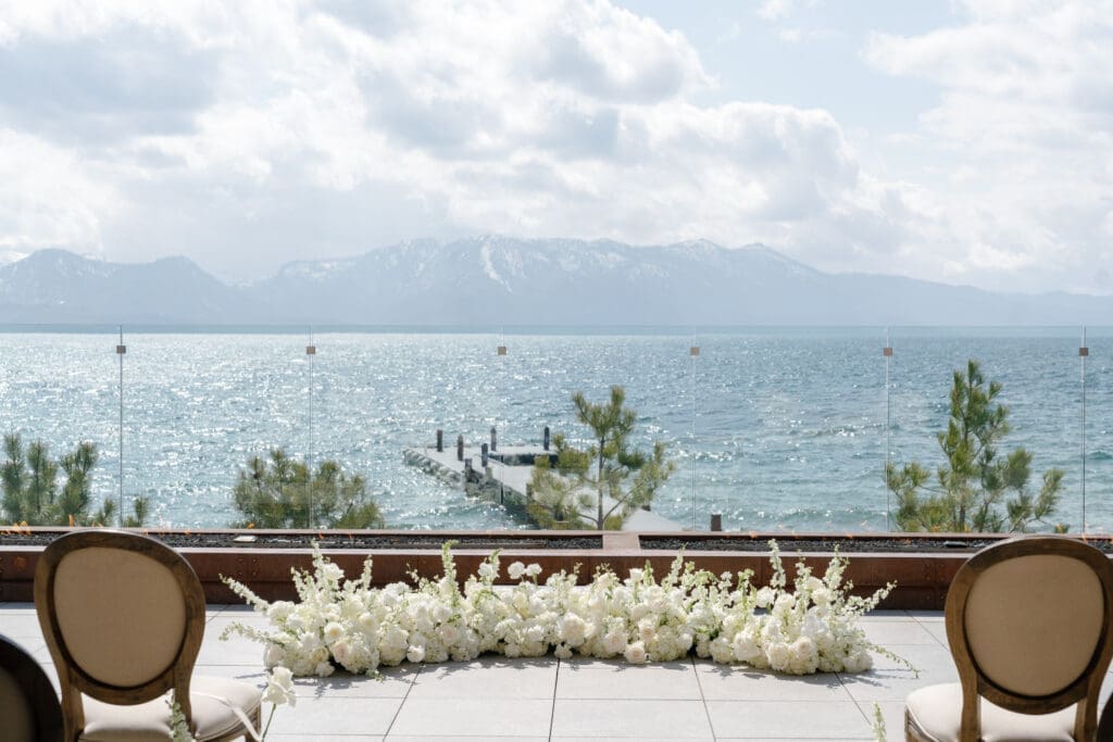 Lakefront wedding ceremony setup at Tahoe Beach Club with panoramic water and mountain views