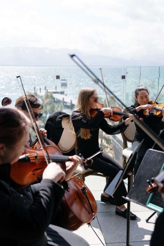 Live string quartet performing during a luxury Tahoe Beach Club wedding ceremony overlooking Lake Tahoe