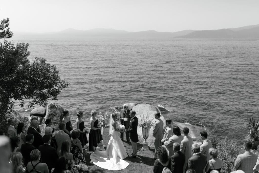 Black and white overhead view of intimate lakeside wedding ceremony at Thunderbird Lodge