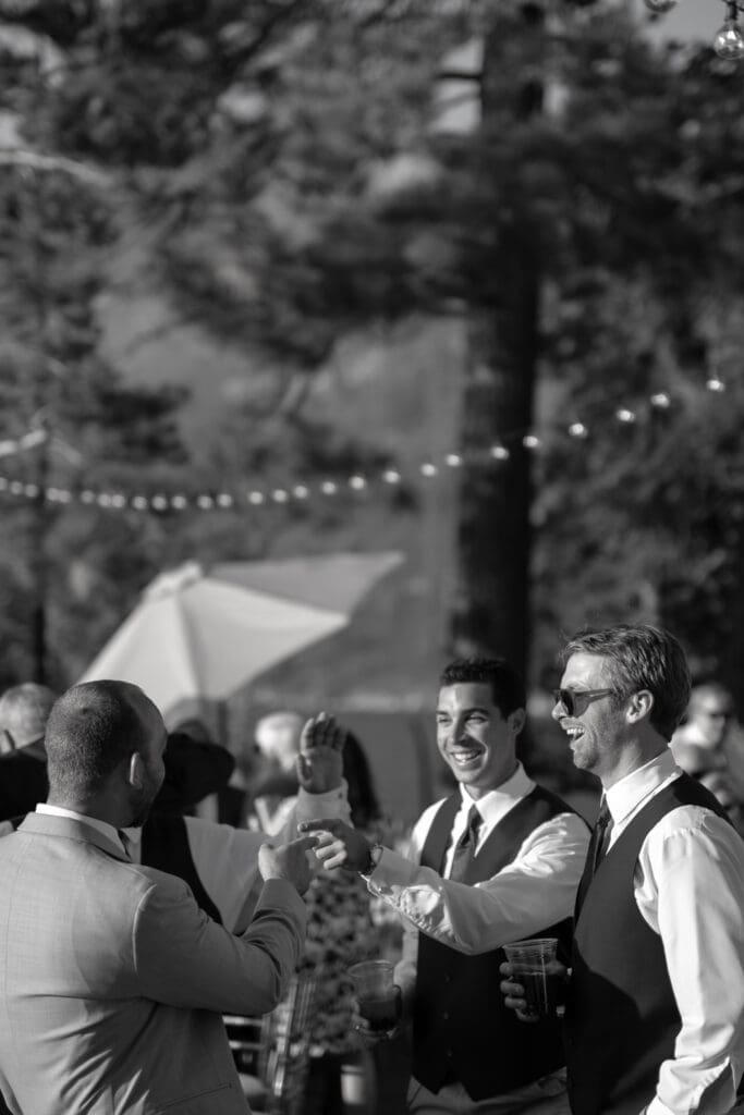 Wedding guests celebrating during outdoor cocktail hour at Thunderbird Lodge in Lake Tahoe