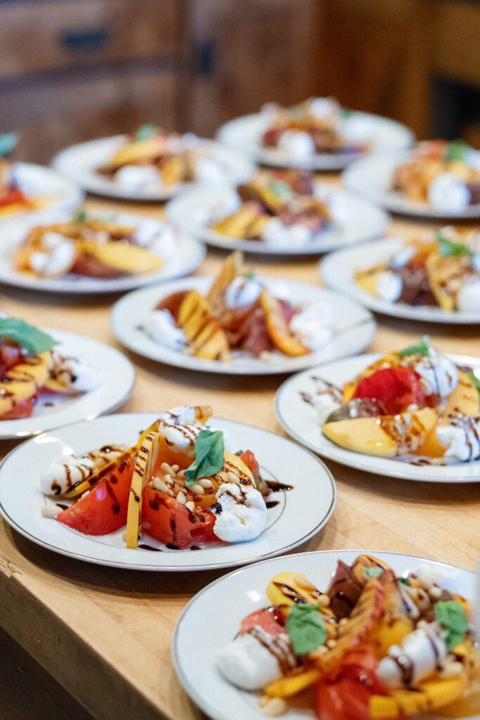 Elegant plated appetizers featuring roasted vegetables, fresh herbs, and delicate garnishes prepared for a luxury Lake Tahoe wedding reception.