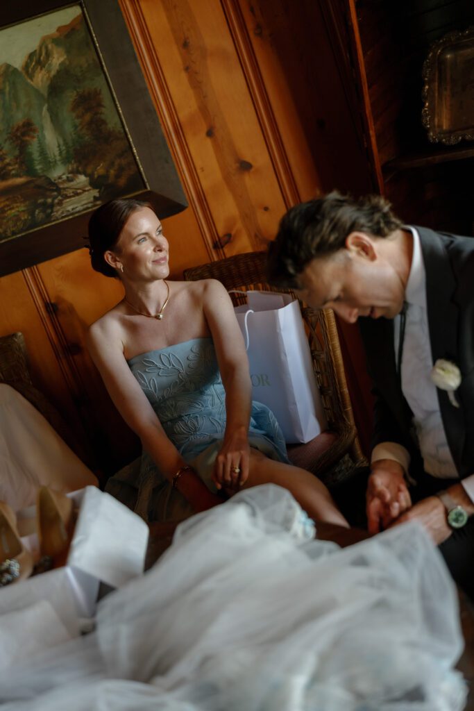 Bride in a pale blue gown smiling at a guest in a wood-paneled reception space during an intimate fall wedding in Lake Tahoe.