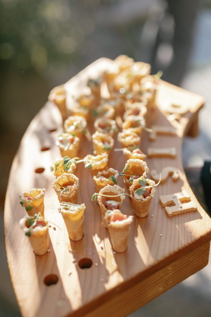 Elegant bite-sized appetizers arranged on a wooden serving tray during a luxury Glenbrook Lake Tahoe wedding reception.